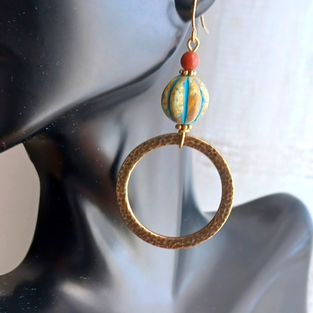 Embossed brass circle earrings.   Handcrafted by us.